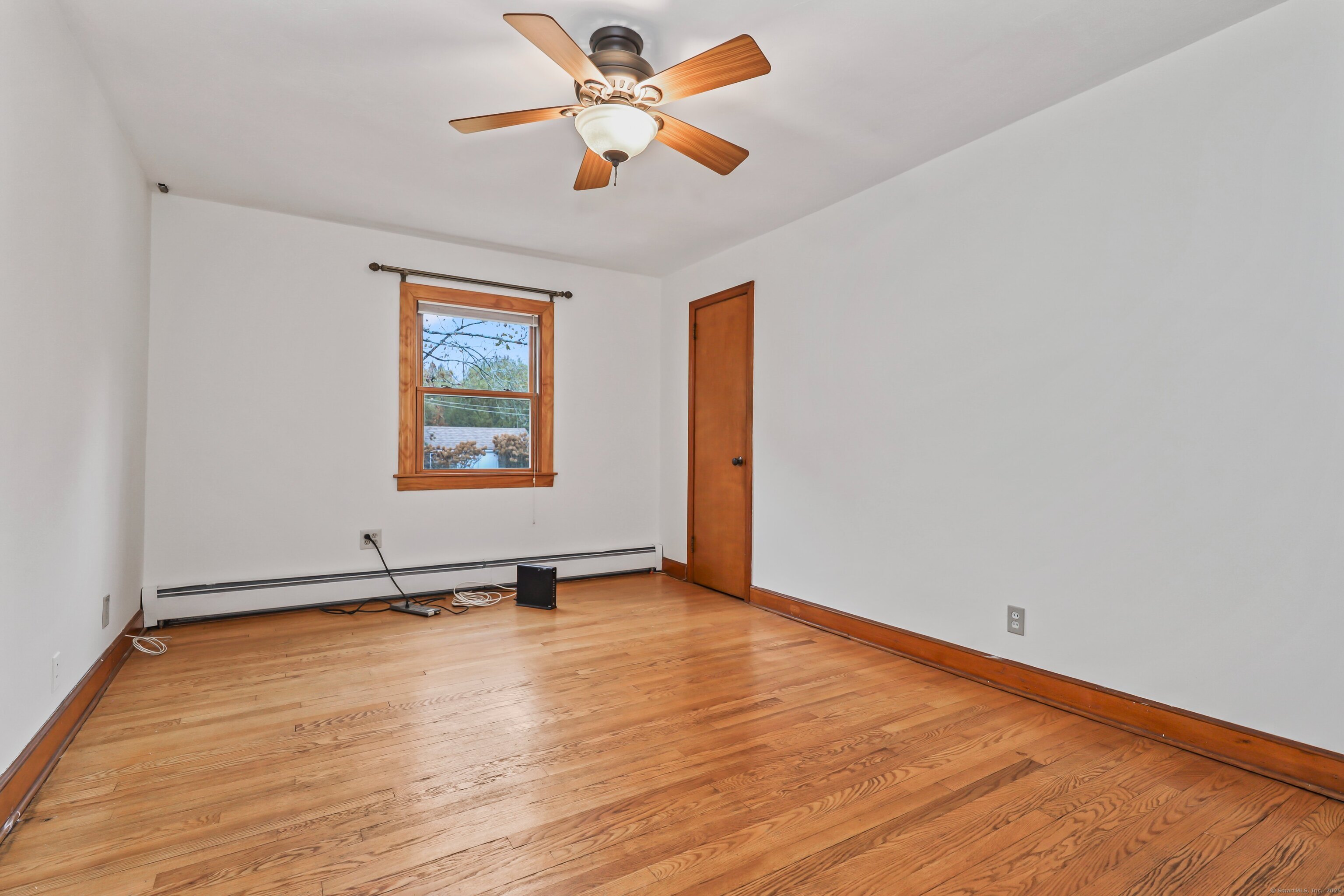 9 Sunset Drive Middlefield, CT 06481 - Photo 16 of 40 an empty room with wooden floor chandelier fan and windows