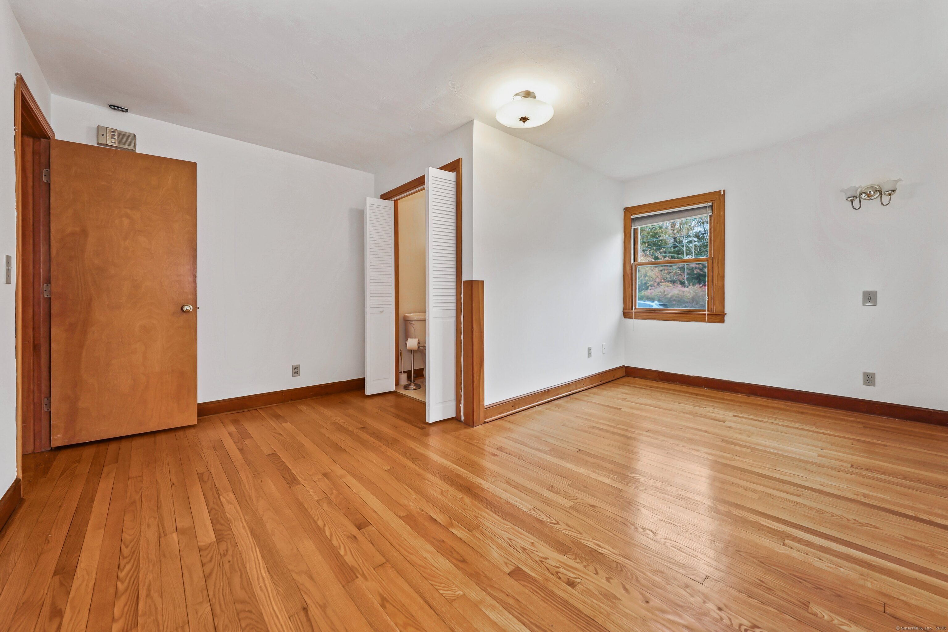 9 Sunset Drive Middlefield, CT 06481 - Photo 18 of 40 a view of an empty room with wooden floor and a window