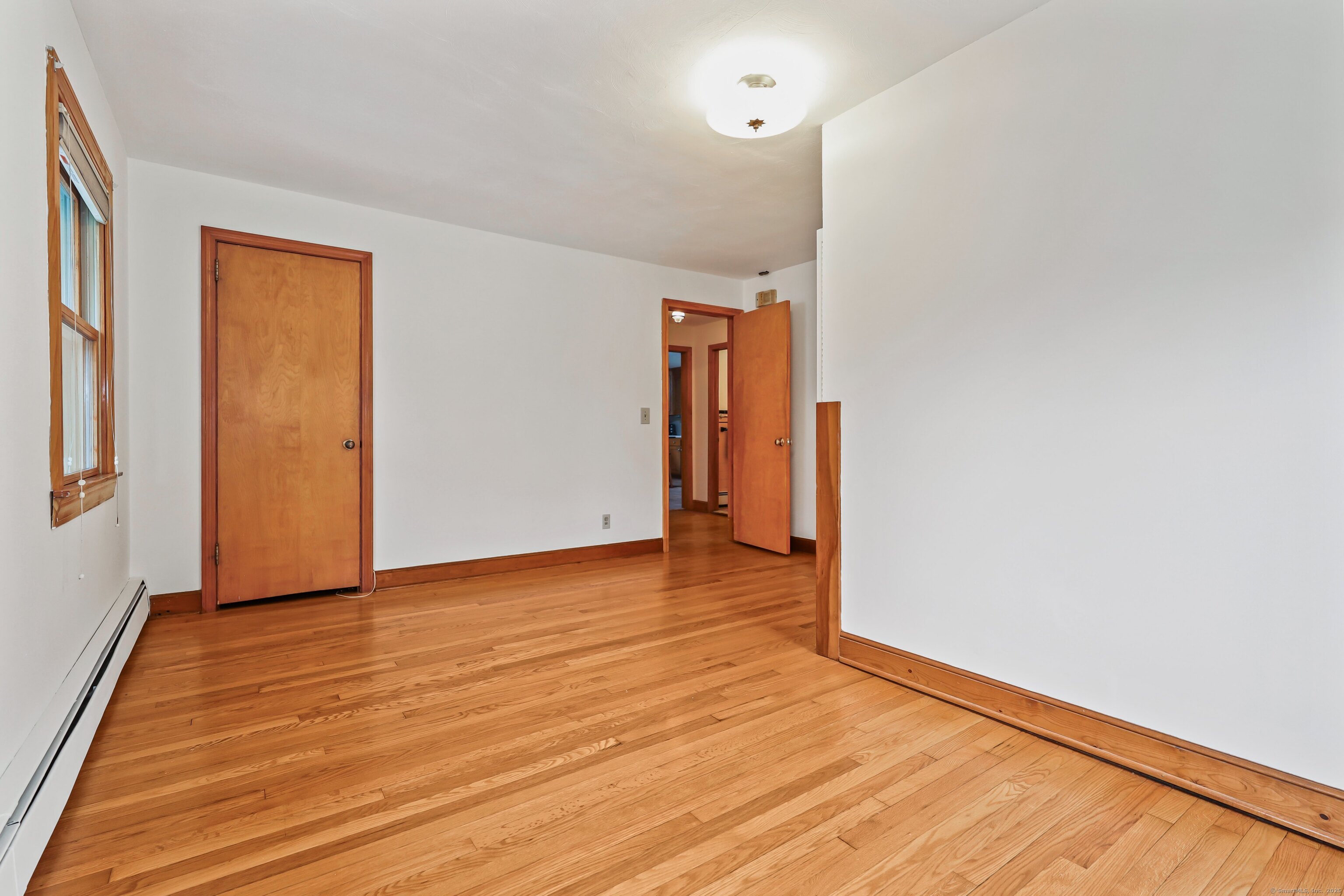 9 Sunset Drive Middlefield, CT 06481 - Photo 19 of 40 a view of an empty room with wooden floor and a window