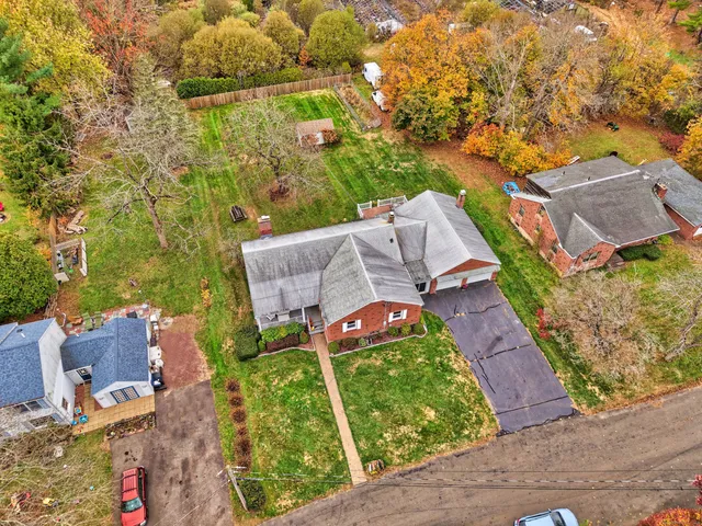 an aerial view of a house with garden space and street view