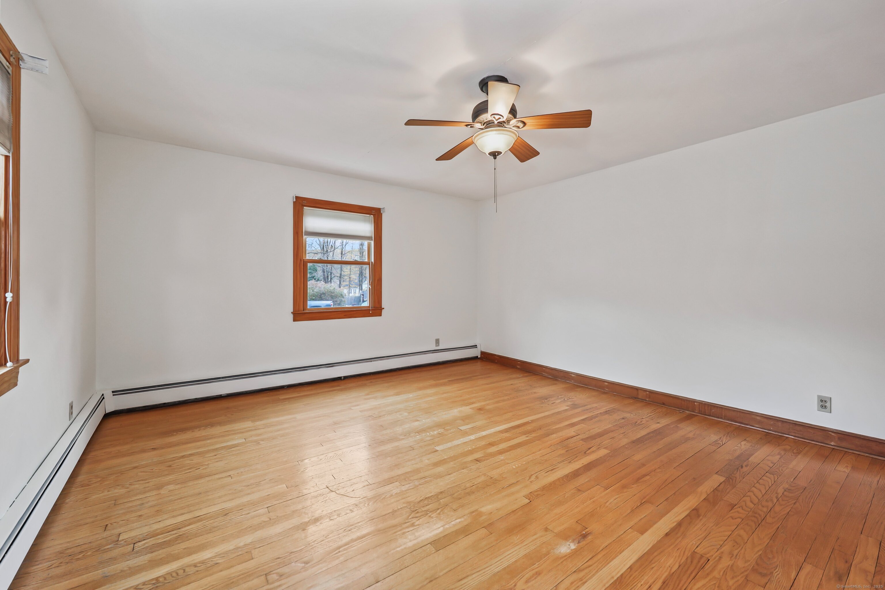9 Sunset Drive Middlefield, CT 06481 - Photo 24 of 40 an empty room with wooden floor chandelier fan and windows