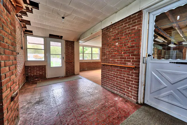 wooden floor in an empty room with a fireplace
