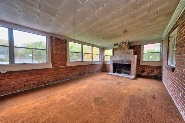 an empty room with furniture and a fireplace