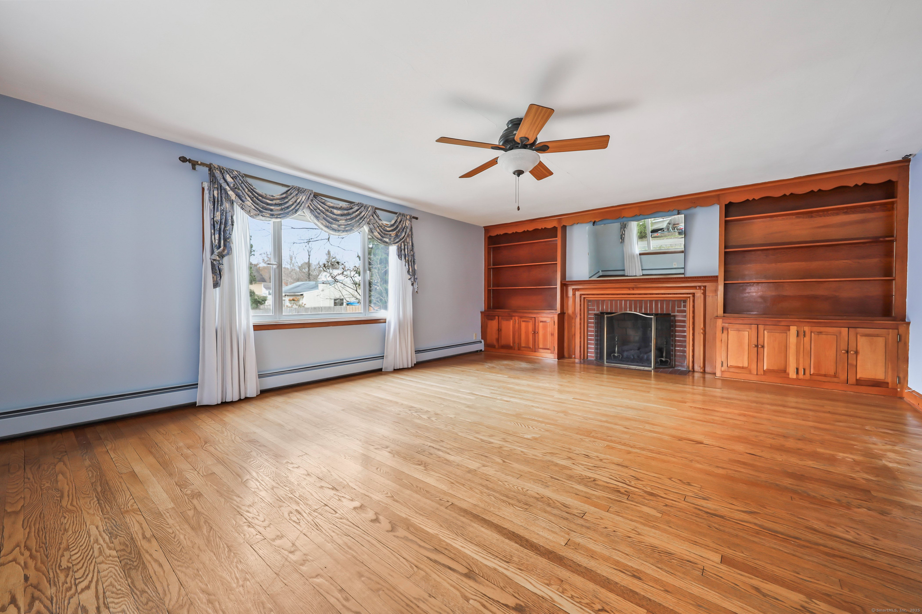 9 Sunset Drive Middlefield, CT 06481 - Photo 4 of 40 a view of empty room with a fireplace and fan
