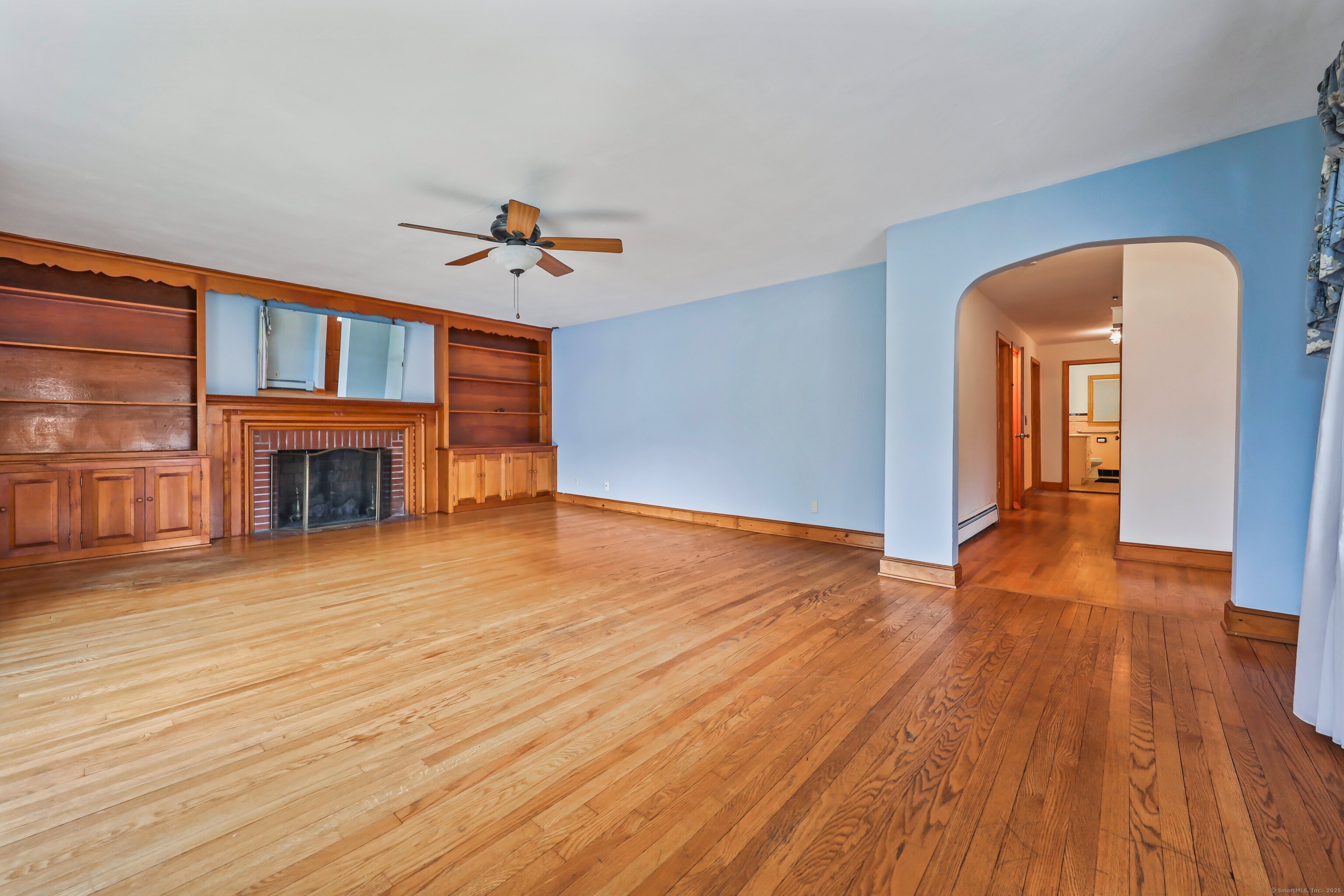 9 Sunset Drive Middlefield, CT 06481 - Photo 5 of 40 an empty room with wooden floor fireplace and windows