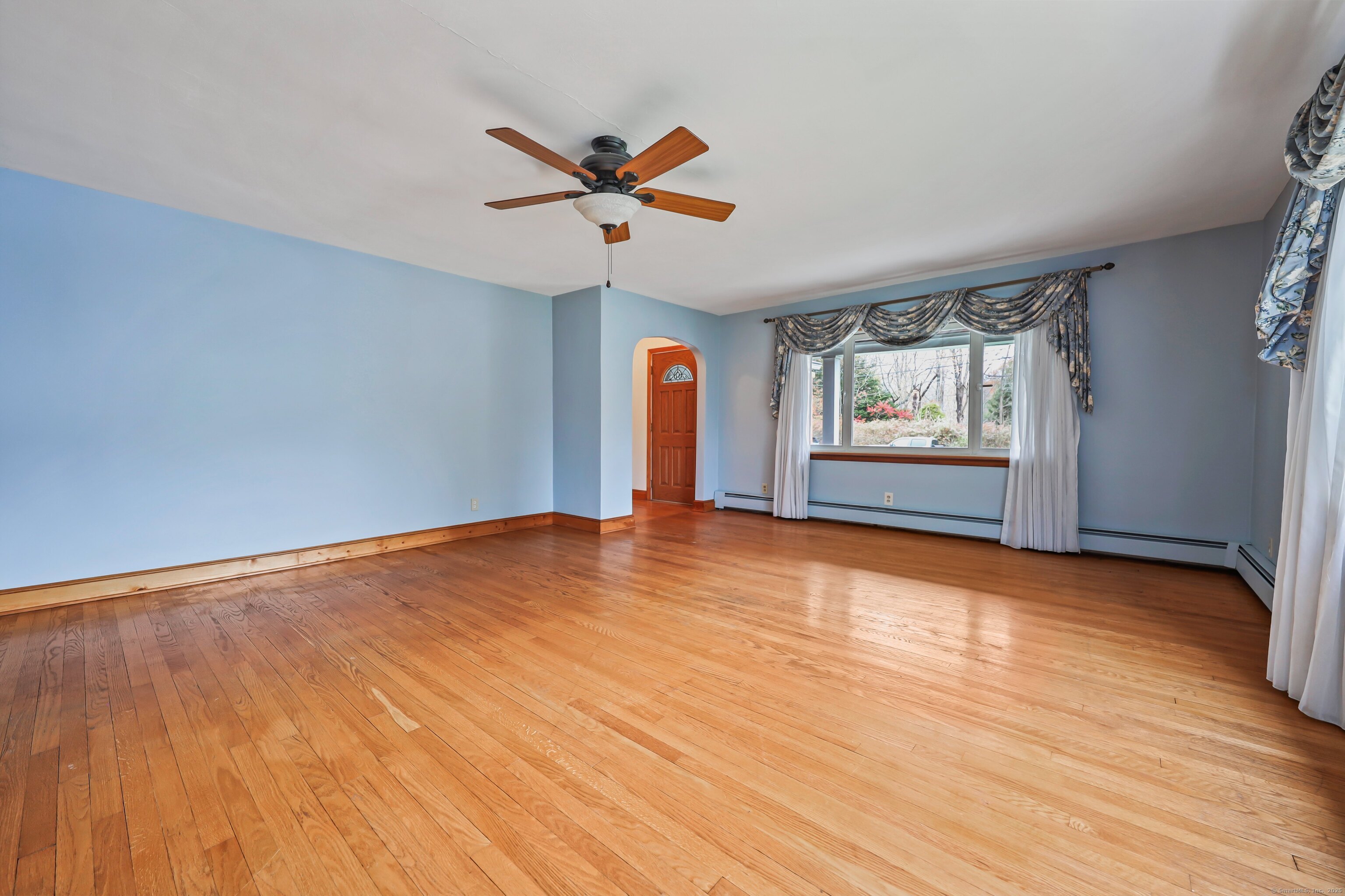 9 Sunset Drive Middlefield, CT 06481 - Photo 6 of 40 a view of an empty room with window and wooden floor