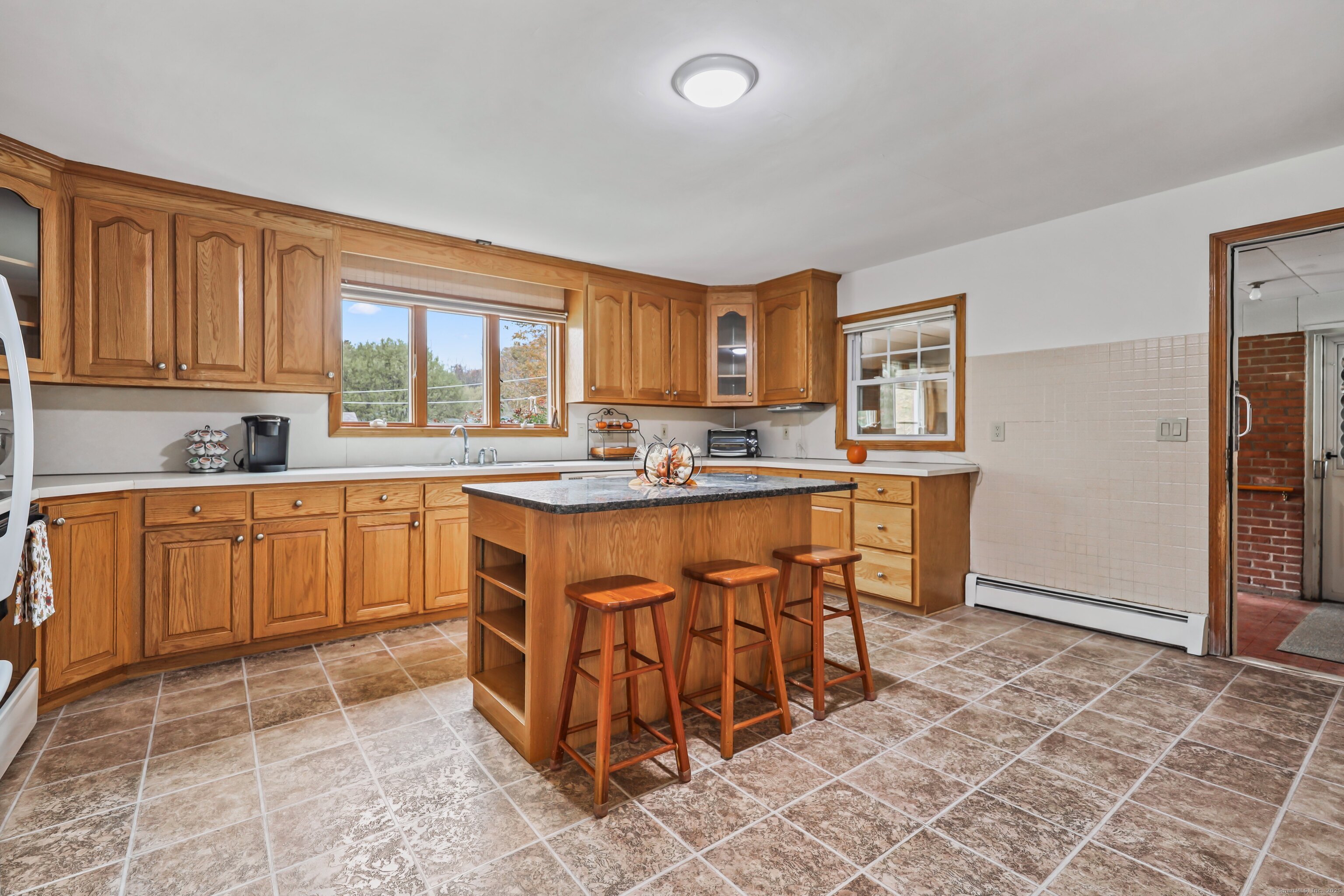 9 Sunset Drive Middlefield, CT 06481 - Photo 8 of 40 a kitchen with stainless steel appliances a sink a stove a refrigerator cabinets and a window