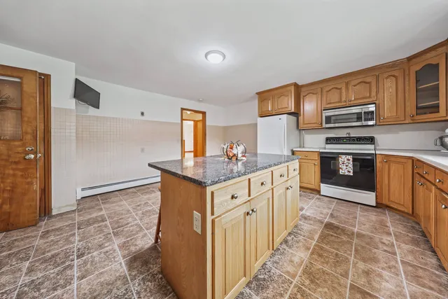 a kitchen with stainless steel appliances granite countertop a stove and a sink