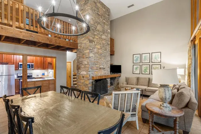 a view of a livingroom with furniture and a black umbrella