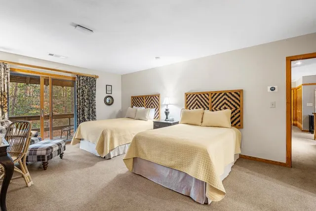 a bathroom with a granite countertop double vanity sink and a mirror