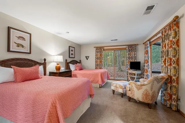 a bedroom with double bed and a couch