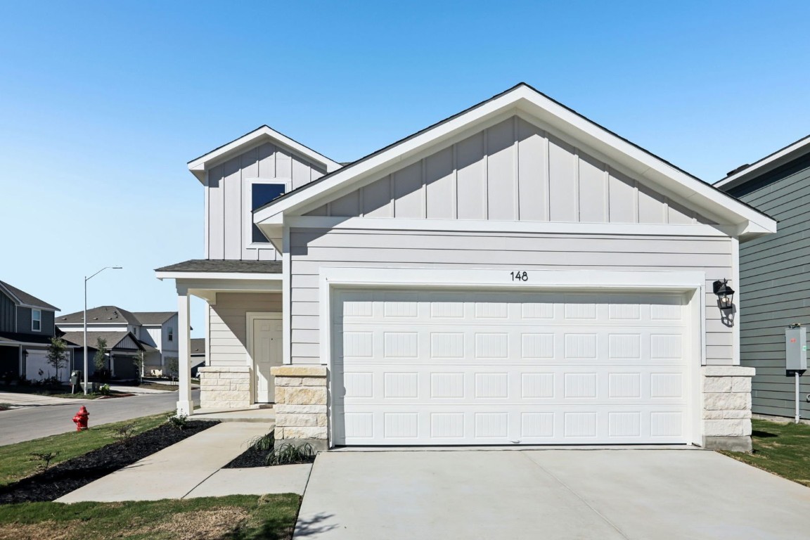 a front view of a house with garage