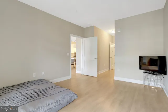 a view of a livingroom with wooden floor and a flat screen tv