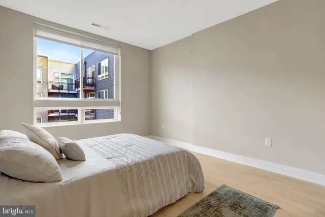 a bedroom with a bed and a window