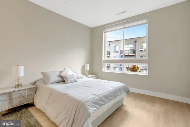 a bedroom with a bed and a window