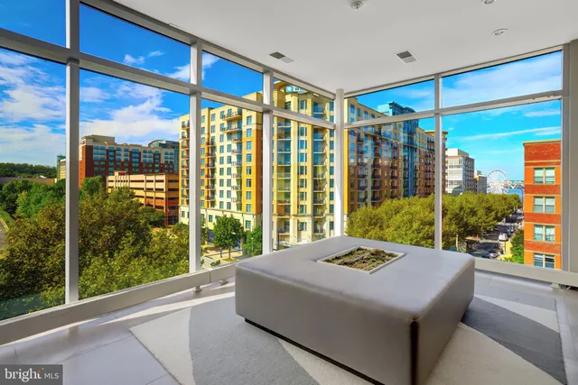 a bedroom with a large window and a balcony