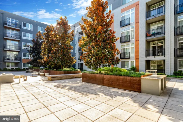a large living room with a large window a table and chairs