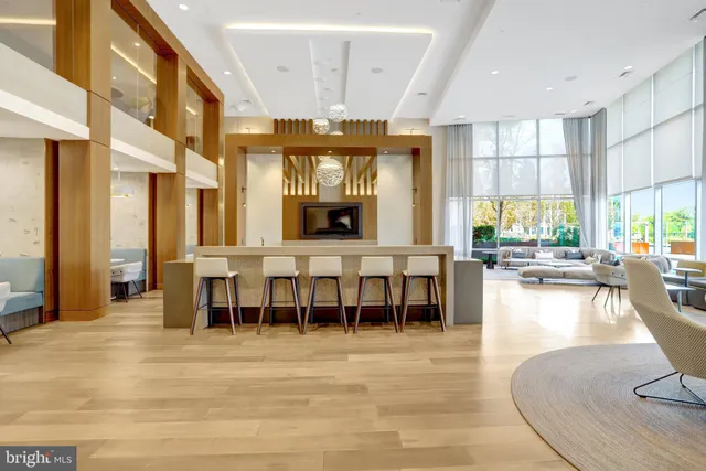 a living room with furniture and large windows