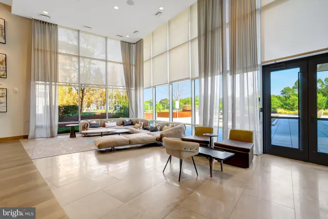 a view of a patio with table and chairs potted plants and a large tree