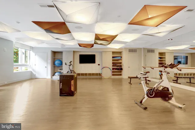 a view of a building and car parked on the side of road