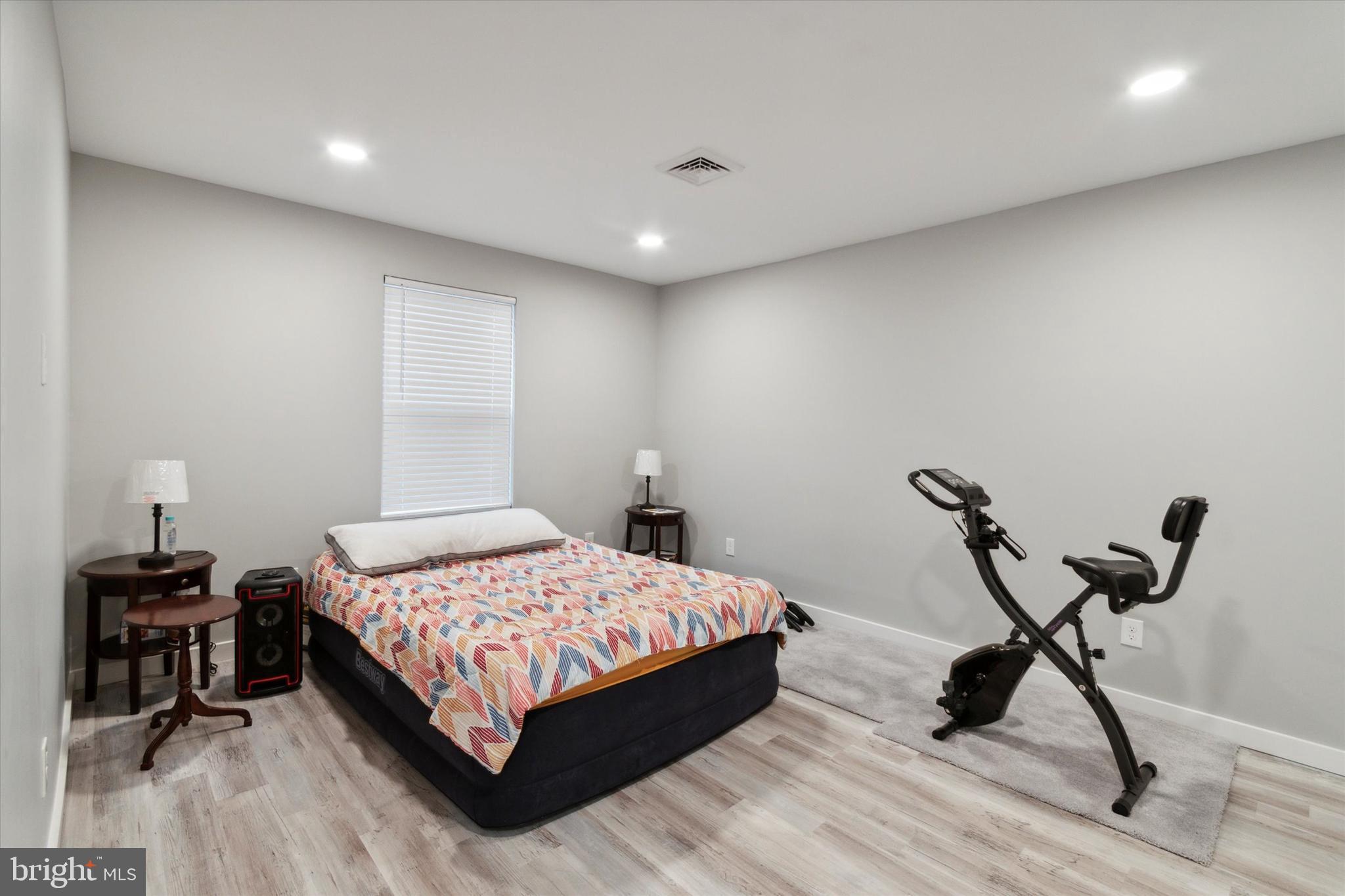 113 Kresson Gibbsboro Road, Unit 2 Voorhees, NJ 08043 - Photo 14 of 25 a bedroom with a bed and a chandelier