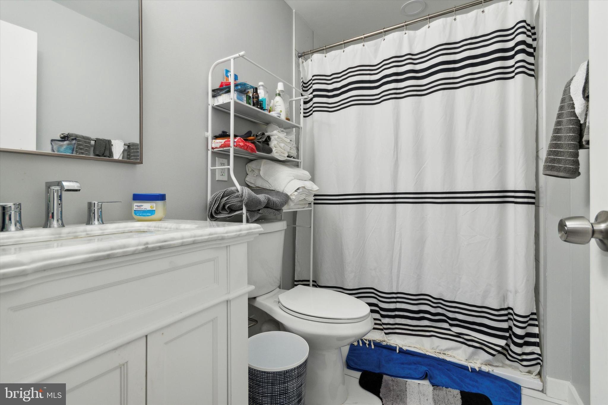 113 Kresson Gibbsboro Road, Unit 2 Voorhees, NJ 08043 - Photo 20 of 25 a bathroom with a sink a toilet and a shower curtain