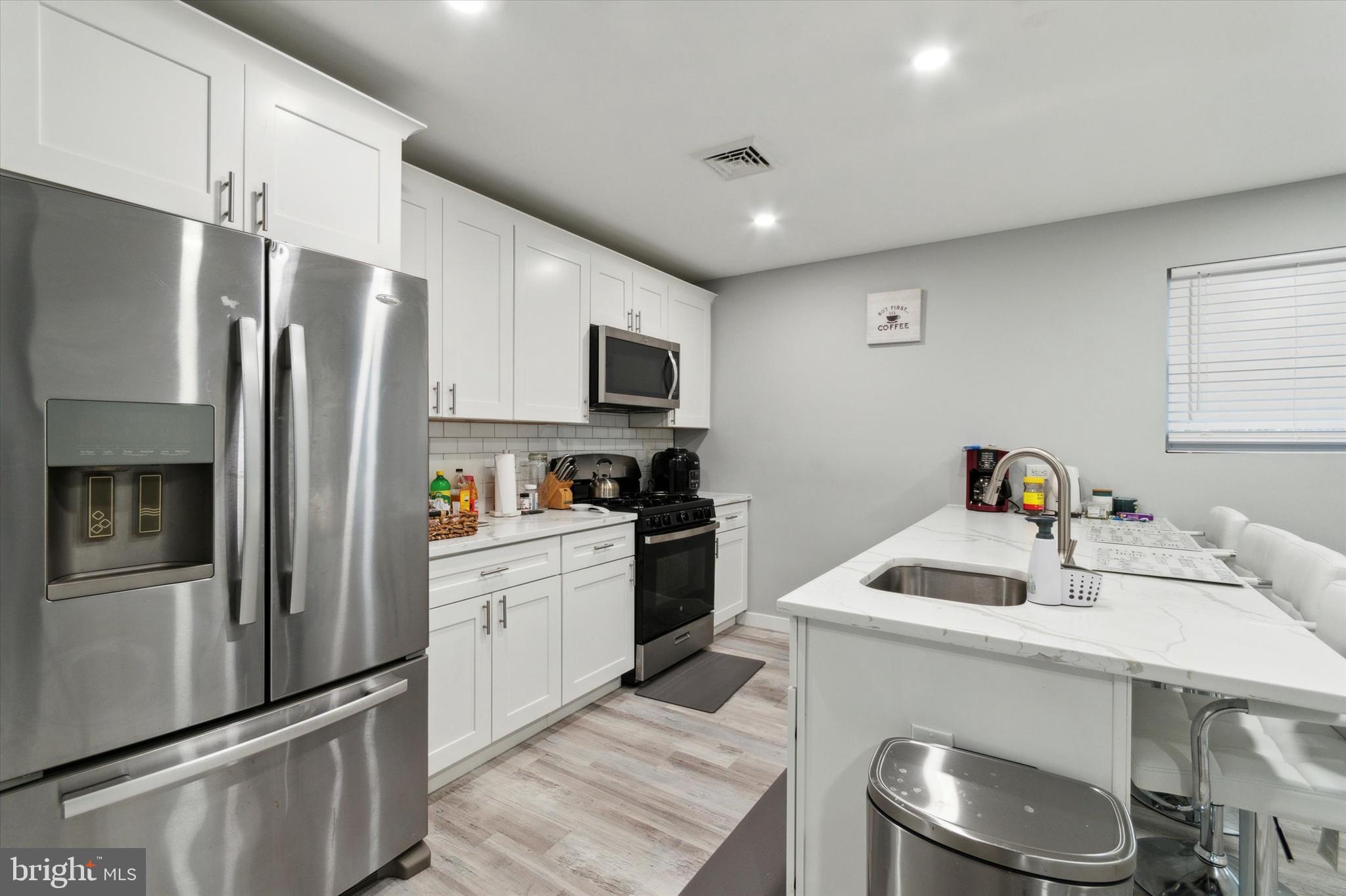 113 Kresson Gibbsboro Road, Unit 2 Voorhees, NJ 08043 - Photo 3 of 25 a kitchen with a sink a refrigerator and cabinets