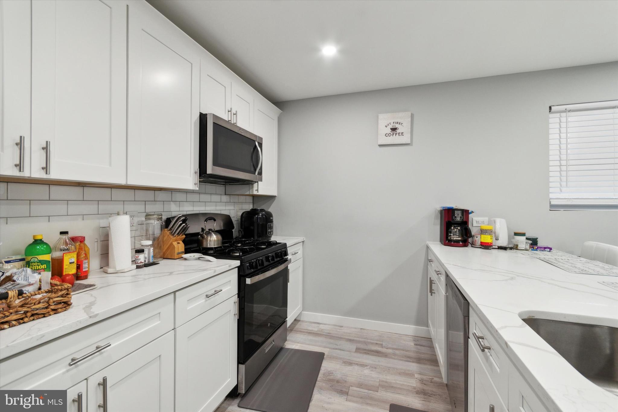 113 Kresson Gibbsboro Road, Unit 2 Voorhees, NJ 08043 - Photo 4 of 25 a kitchen with a sink a stove and cabinets