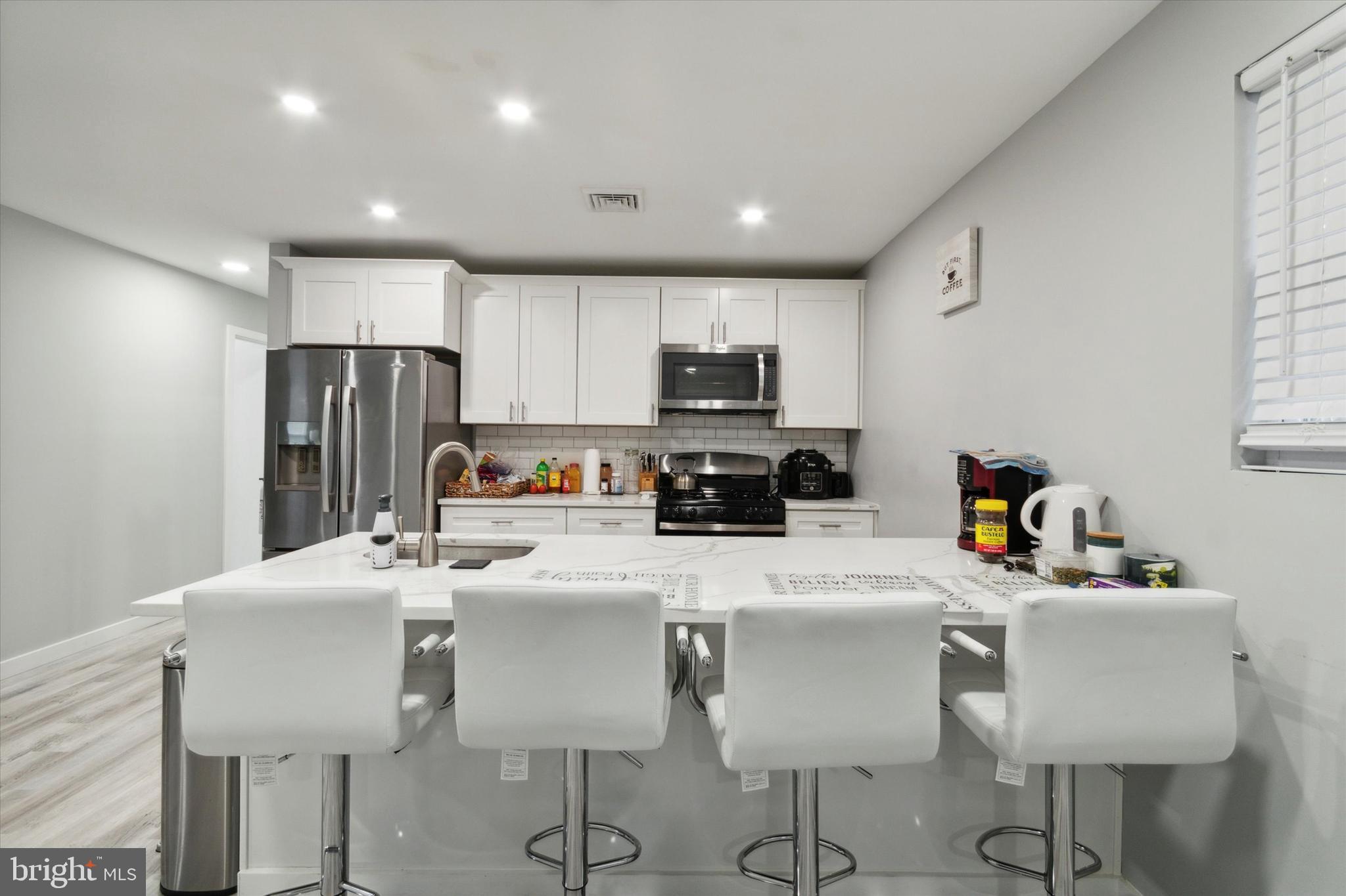113 Kresson Gibbsboro Road, Unit 2 Voorhees, NJ 08043 - Photo 6 of 25 a kitchen with stainless steel appliances granite countertop a dining table chairs refrigerator and sink
