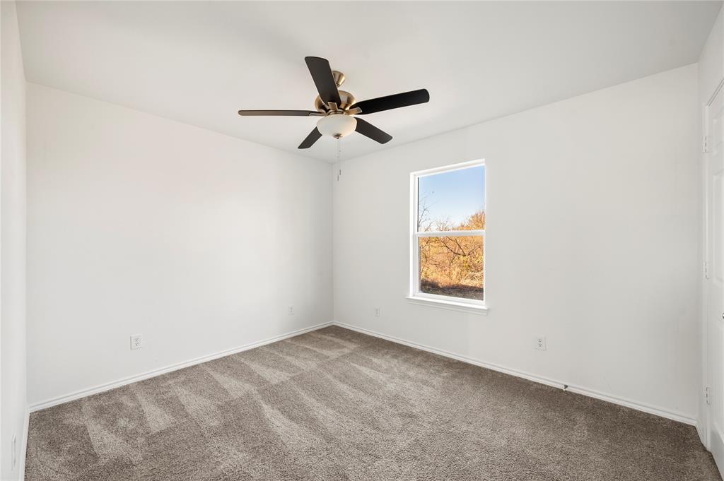 437 Whitney Court Rio Vista, TX 76093 - Photo 11 of 21 an empty room with a window and a ceiling fan