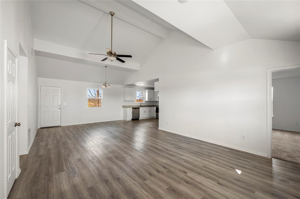 437 Whitney Court Rio Vista, TX 76093 - Photo 3 of 21 an empty room with wooden floor ceiling fan and windows