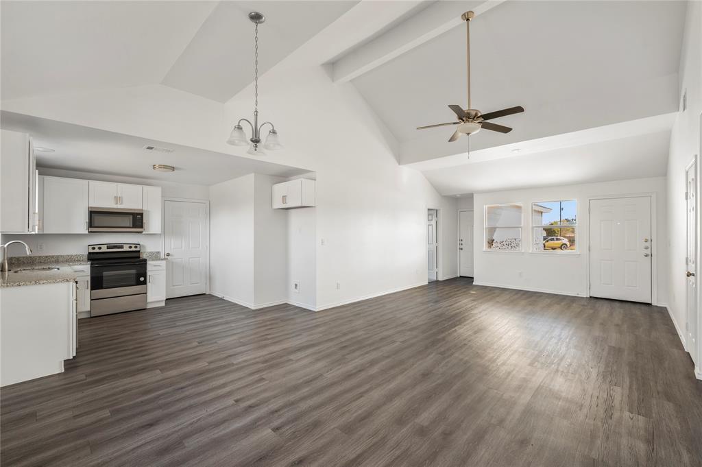 437 Whitney Court Rio Vista, TX 76093 - Photo 4 of 21 a view of a kitchen with a sink dishwasher stove and wooden floor
