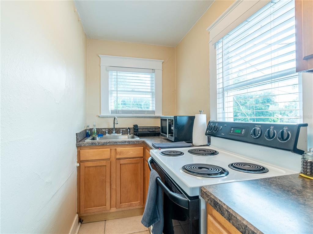 103 East Mohawk Avenue, Unit A Tampa, FL 33604 - Photo 12 of 19 a kitchen that has a stove and a table