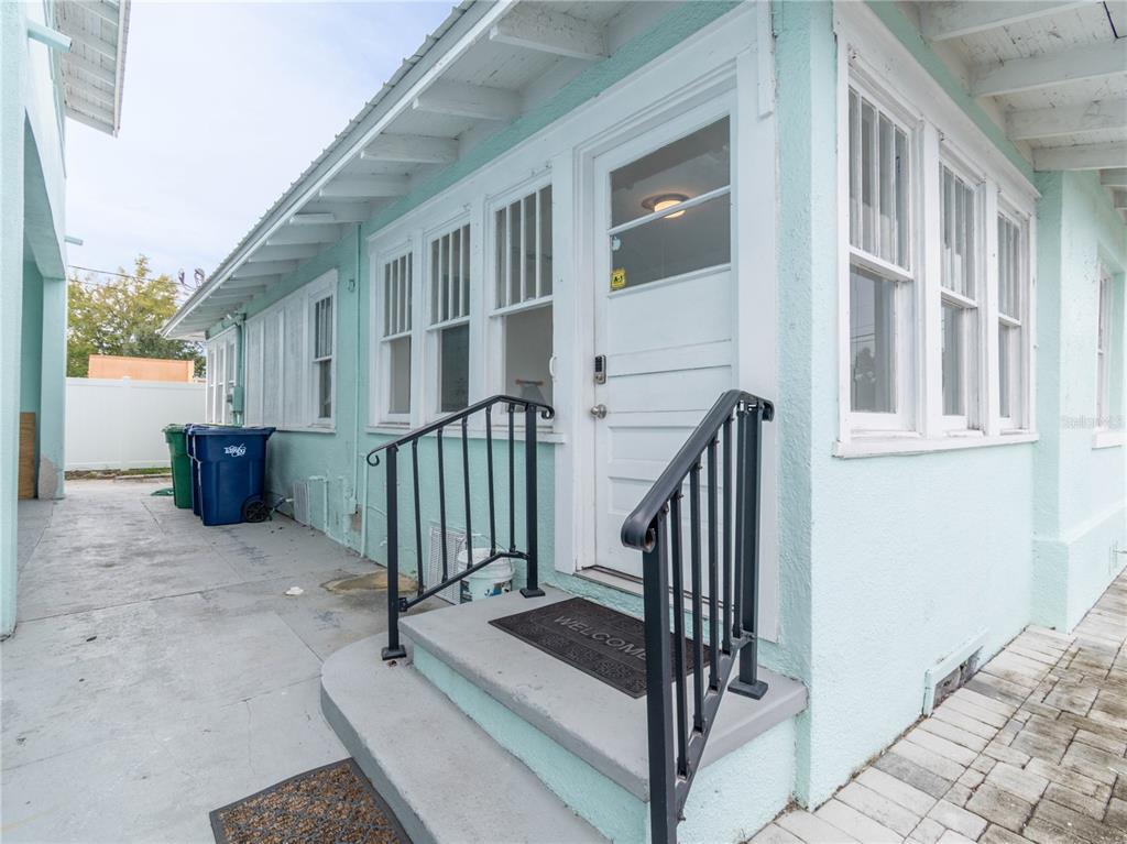 103 East Mohawk Avenue, Unit A Tampa, FL 33604 - Photo 18 of 19 a view of porch with two chairs and a gate