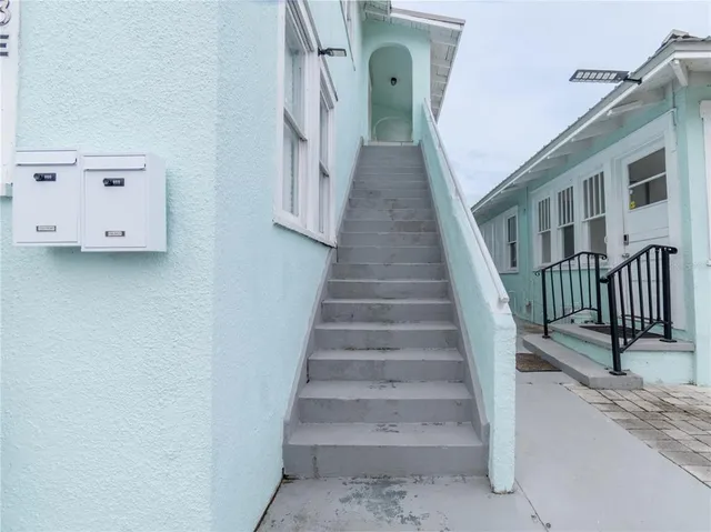 a view of staircase with white walls and railing