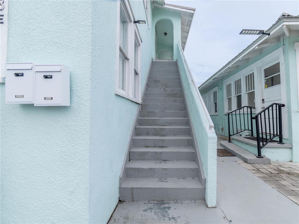 103 East Mohawk Avenue, Unit A Tampa, FL 33604 - Photo 2 of 19 a view of staircase with white walls and railing