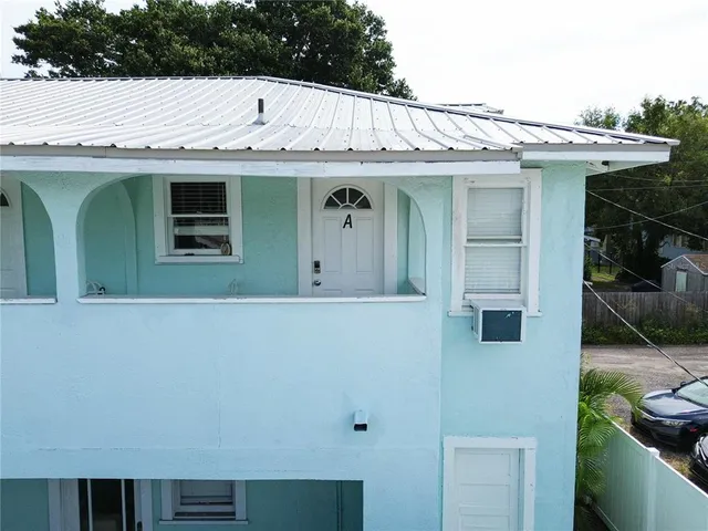 a view of a white house with many windows