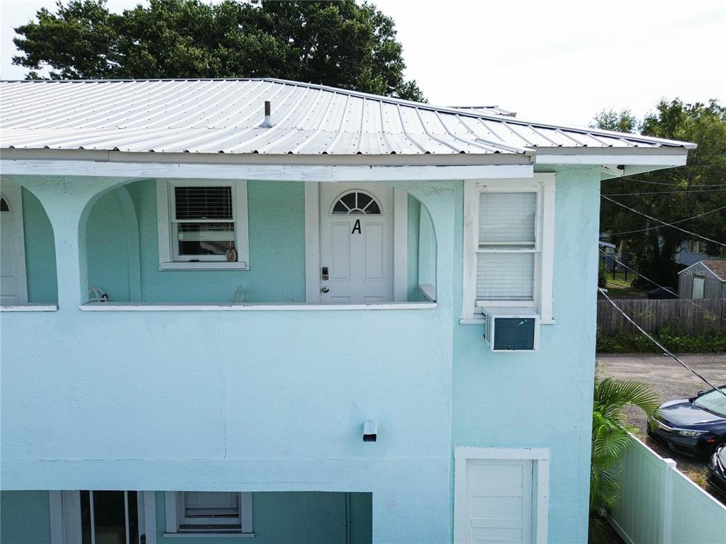 103 East Mohawk Avenue, Unit A Tampa, FL 33604 - Photo 4 of 19 a view of a white house with many windows