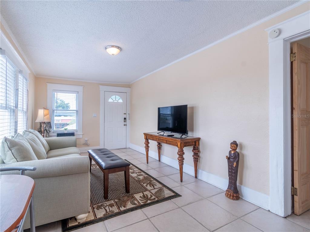 103 East Mohawk Avenue, Unit A Tampa, FL 33604 - Photo 6 of 19 a living room with furniture and a flat screen tv