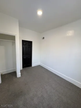 an empty room with an empty space and bathroom
