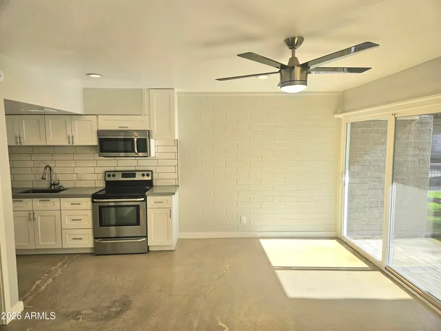 a kitchen with stainless steel appliances granite countertop a stove a sink and a refrigerator