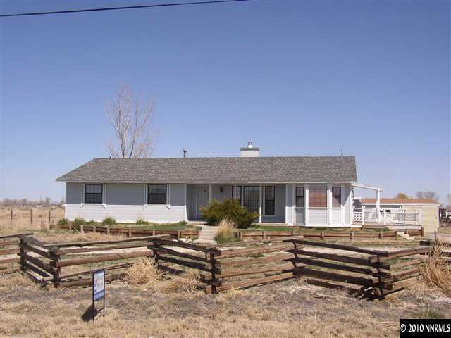 4100 Schindler Road Fallon, NV 89406 - Photo 1 of 7 a front view of a house with a bench
