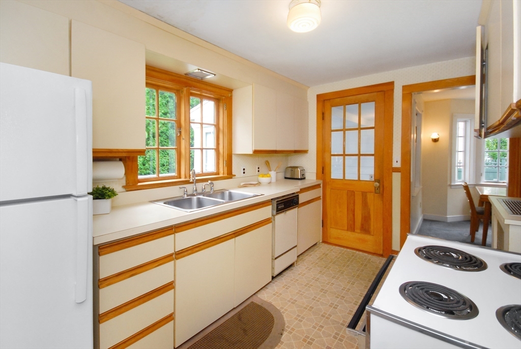 3 Sherburne Road Lexington, MA 02421 - Photo 19 of 42 a kitchen with a refrigerator a sink and a window