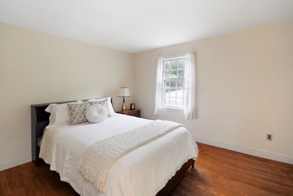 3 Sherburne Road Lexington, MA 02421 - Photo 24 of 42 a bedroom with a bed and wooden floor