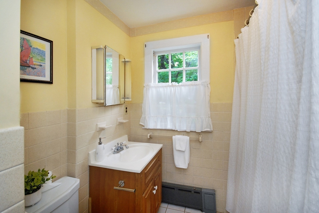 3 Sherburne Road Lexington, MA 02421 - Photo 27 of 42 a bathroom with a sink a mirror and a shower