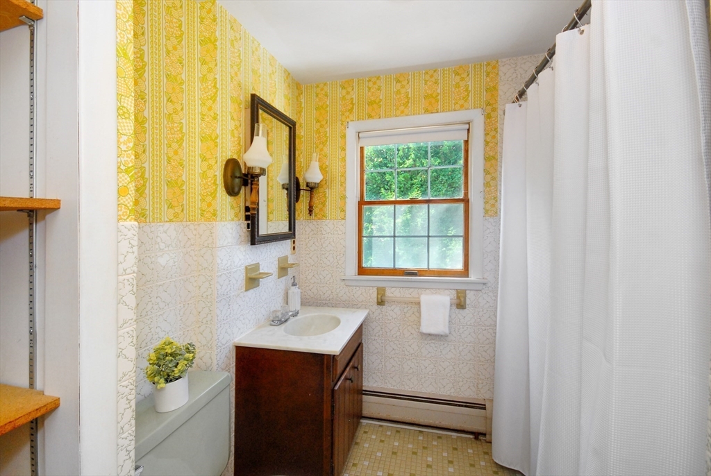 3 Sherburne Road Lexington, MA 02421 - Photo 33 of 42 a bathroom with a sink and a mirror