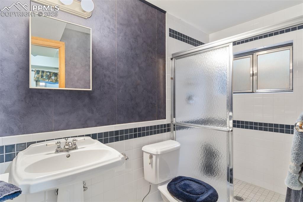 5580 Moosa Road Cascade, CO 80809 - Photo 28 of 35 a bathroom with a sink a toilet and a mirror