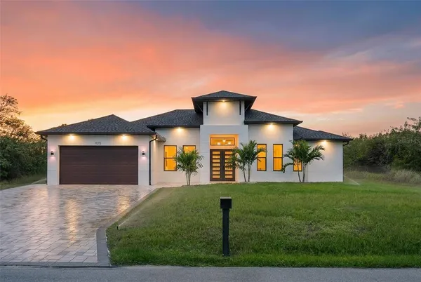 a front view of a house with a yard and garage