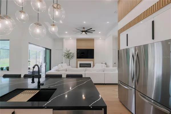 a large kitchen with stainless steel appliances a large island in the center