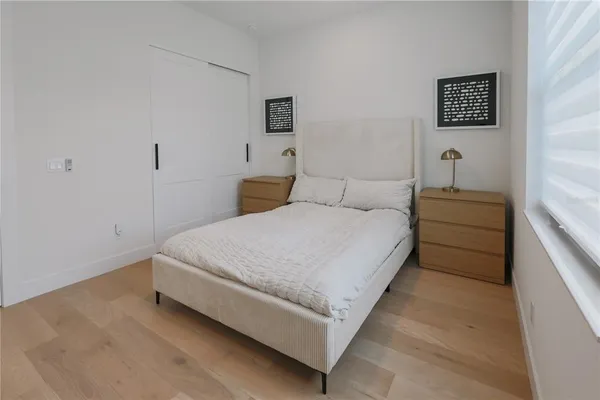 a bedroom with a bed and a night stand